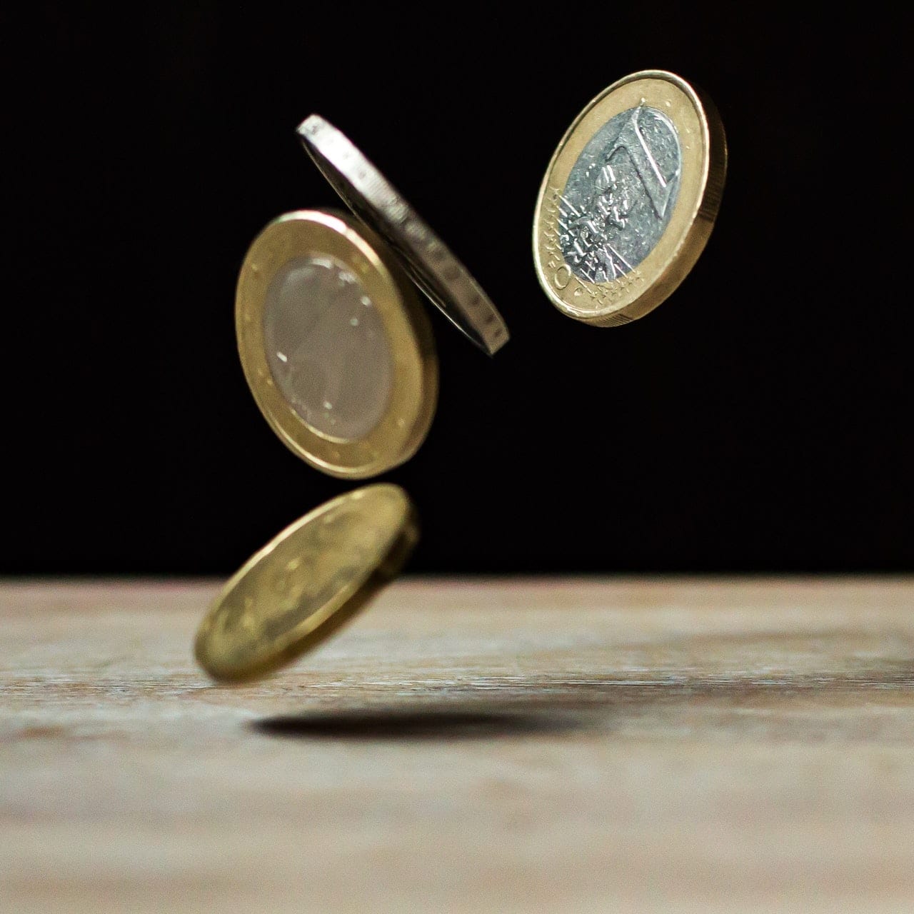 coins falling on table